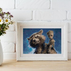 May include: A framed print of Rocket Raccoon and Groot from Guardians of the Galaxy. Rocket is looking at the viewer with a mischievous grin, while Groot is perched on his shoulder. The background is a dark blue with white stars.
