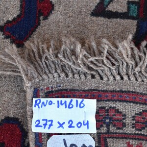 May include: A beige rug with a geometric pattern in shades of blue, red, and green. The rug has a fringe border and a label that reads "RNo. 14616 277 x 204".