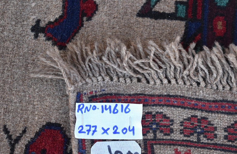 May include: A beige rug with a geometric pattern in shades of blue, red, and green. The rug has a fringe border and a label that reads "RNo. 14616 277 x 204".