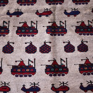 May include: A beige rug with a repeating pattern of stylized helicopters and tanks. The helicopters are blue and the tanks are red, white, and blue.