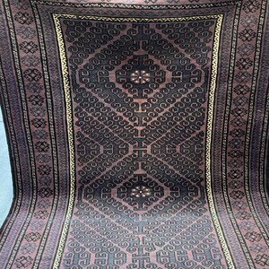 Può includere: Un tappeto rettangolare a fantasia con un motivo a diamante centrale in grigio scuro e bordeaux. Il tappeto presenta intricati motivi geometrici e un bordo con motivi ripetuti. Il tappeto è realizzato in materiale tessuto.