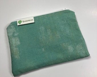 May include: A small green zippered pouch with a white zipper and a green and white label that says "Greentree".