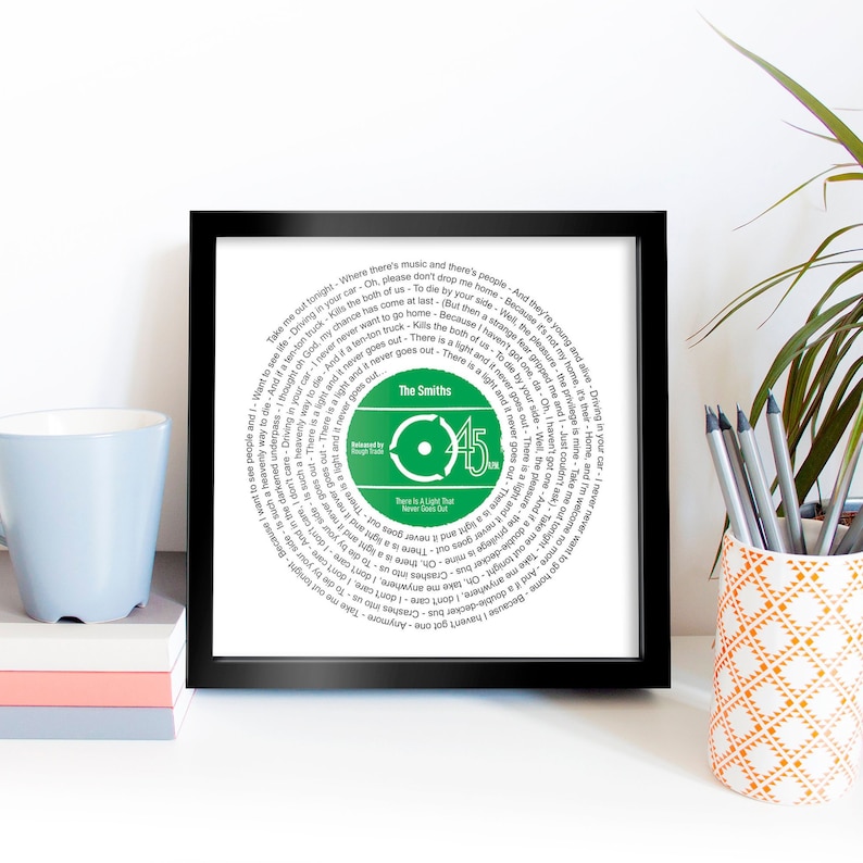 May include: A framed print of a green vinyl record with the lyrics to The Smiths song "There Is A Light That Never Goes Out" printed in a circle around the record. The record is labeled "The Smiths" and "45 RPM".