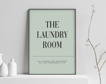 May include: A framed print with a light green background and black text that reads "The Laundry Room. All change left in pockets will be considered a tip."
