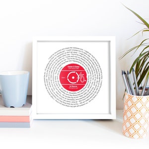 May include: A white framed print with a red vinyl record design. The record features the lyrics to the song "Thinking Out Loud" by Ed Sheeran. The record also includes the text "Steven & Emma 25th January 2018" and "Side A 45".