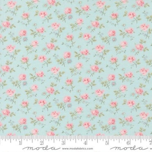 May include: A fabric with a repeating floral pattern. Pink roses and small blue flowers are scattered across a light blue background. The fabric has a vintage, cottagecore aesthetic, suitable for quilting or sewing projects.