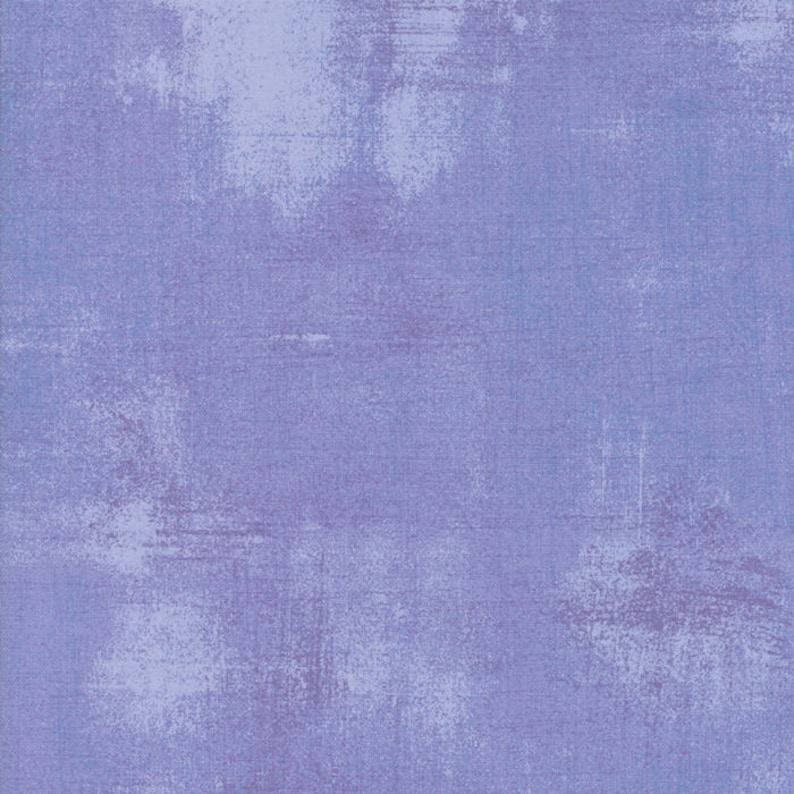 May include: A textured background in a light blue color with a subtle purple hue.