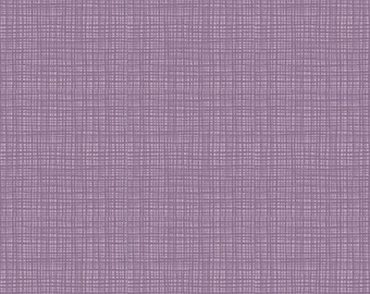 May include: A close-up of a fabric with a woven texture in shades of purple and lavender. The fabric has a grid-like pattern, with vertical and horizontal lines intersecting. The image includes a ruler with inches.