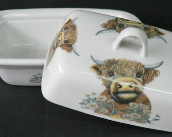Highland cow butter dish  Cute highland cow  design on white porcelain butter dish decorated on lid and sides with flowers from image