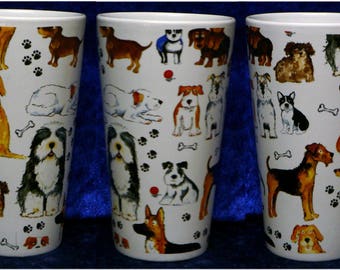 May include: Three white ceramic mugs with a tall, slender design. Each mug features a different pattern of colorful cartoon dogs with various breeds and poses. The mugs have a black handle and are perfect for coffee, tea, or hot chocolate.