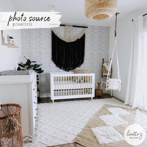 Black and white dots wallpaper in a bohemian interior design nursery for a gender neutral baby
