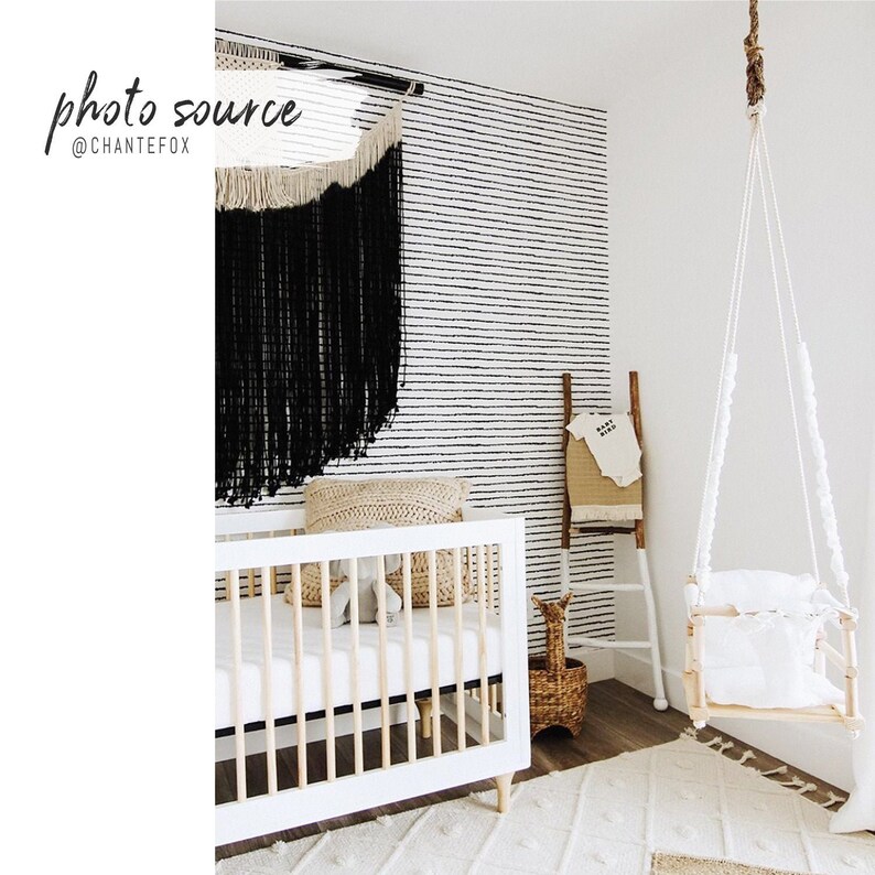 Scandinavian bohemian dots wallpaper in a gender neutral baby room
