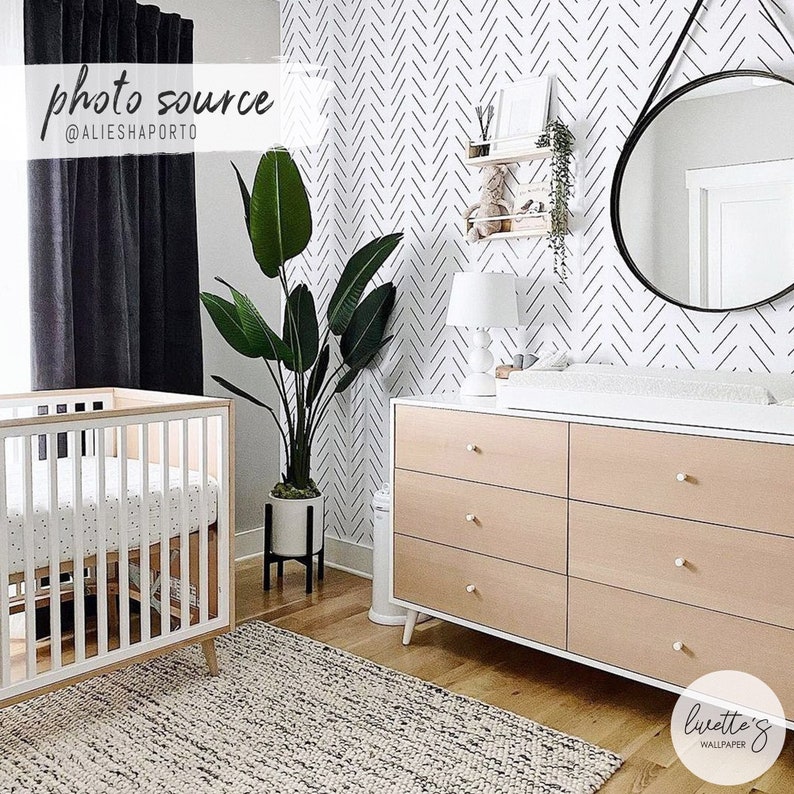 Black and white herringbone wallpaper in modern glam style nursery