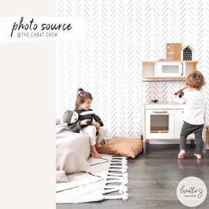 Black and white herringbone removable wallpaper in a bohemian kids room