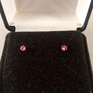 May include: A pair of ruby earrings in a black velvet jewelry box.
