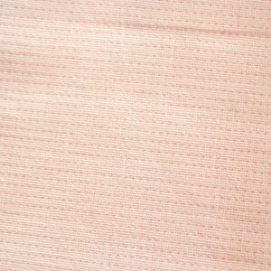 May include: Close-up of a light pink fabric with a textured weave. The fabric has horizontal lines of stitching and a subtle, dotted pattern, creating a soft, tactile appearance. The overall effect is a delicate, neutral textile.