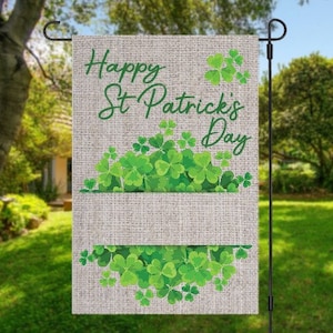 May include: A burlap garden flag with the text "Happy St. Patrick's Day" in green cursive lettering. The flag is decorated with green shamrocks.