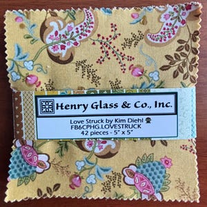 May include: A stack of 42 fabric squares, each 5" x 5", from the "Love Struck" collection by Kim Diehl. The fabric features a yellow background with a floral pattern in pink, brown, and blue. The label reads "Henry Glass & Co., Inc."