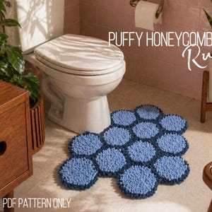 May include: A blue honeycomb rug made of puffy, textured material sits on a bathroom floor. The rug is composed of several connected, circular shapes. The words "PUFFY HONEYCOMB Rug" are written in white script. The text "PDF PATTERN ONLY" is also visible.