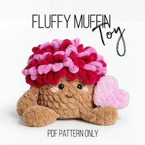 May include: A plush, handmade toy shaped like a muffin, with a brown body and a fluffy, two-tone pink and red top. The toy has a smiling face, small arms and legs, and holds a pink heart. Text on the image reads "FLUFFY MUFFIN Toy" and "PDF PATTERN ONLY."