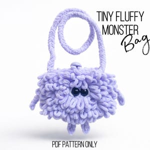 May include: A small, fluffy, lavender monster bag with a loop handle. The bag has two black button eyes and small, stubby arms and legs. Text on the image reads "TINY FLUFFY MONSTER Bag" and "PDF PATTERN ONLY".
