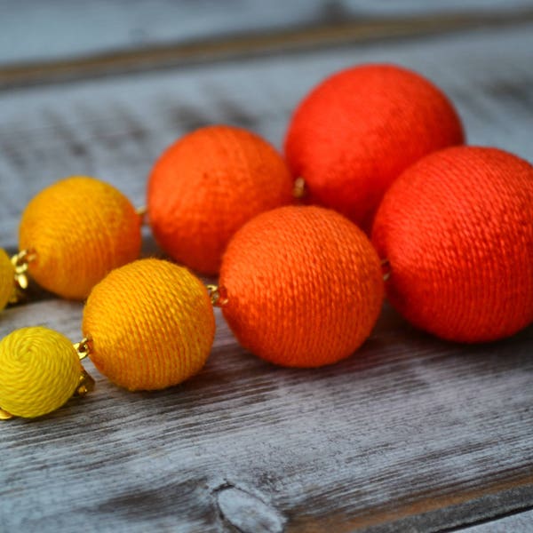 Yellow orange ombre bon bon bonbon earrings Three balls gradient clip earrings Rebecca de Ravenel Les bonbons Ball drop statement earrings