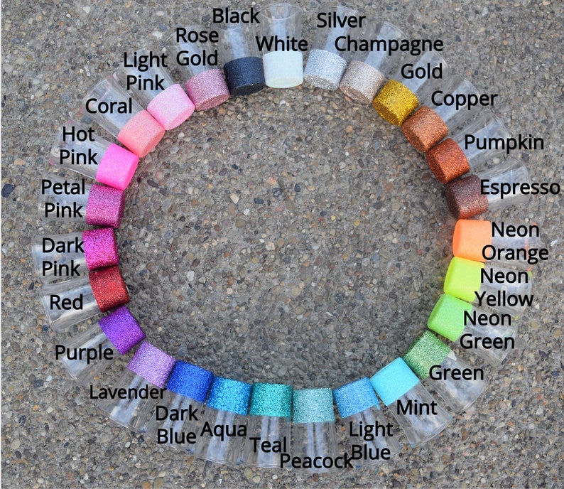 May include: A color chart of glitter in small glass jars. The colors are arranged in a circle, starting with black, white, silver, champagne, gold, copper, pumpkin, espresso, neon orange, neon yellow, neon green, green, mint, light blue, peacock blue, teal, aqua, dark blue, lavender, purple, red, dark pink, petal pink, hot pink, coral, light pink, and light gold.