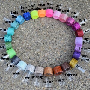 May include: A circle of clear glass shot glasses with different colored glitter rims. The colors include: dark blue, neon yellow, neon orange, neon pink, light pink, pink coral, petal pink, dark pink, red, light purple, lavender, dark purple, gold, espresso, pumpkin, copper, champagne, silver, white, black, neon green, green, teal, mint, and peacock.