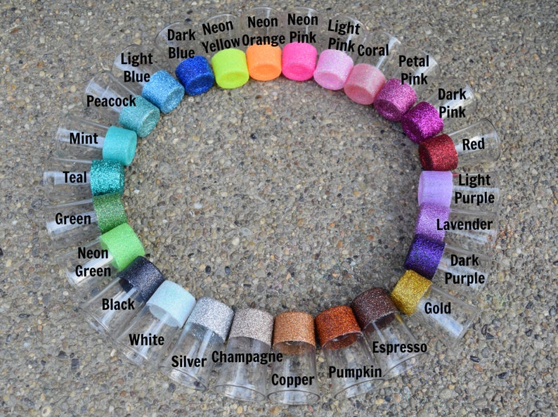 May include: A circle of clear glass shot glasses with different colored glitter rims. The colors include: dark blue, neon yellow, neon orange, neon pink, light pink, pink coral, petal pink, dark pink, red, light purple, lavender, dark purple, gold, espresso, pumpkin, copper, champagne, silver, white, black, neon green, green, teal, mint, and peacock.