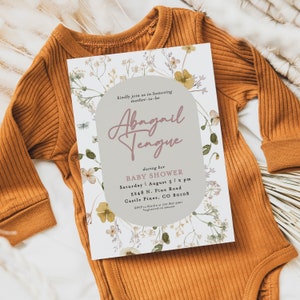May include: A floral baby shower invitation with a light grey background and a light brown circle with the text "kindly join us in honouring mother-to-be Abagail Tengue" in pink script. The invitation details the date, time, and location of the shower.