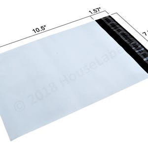 May include: White mailing envelope with a black and silver security strip. The envelope measures 10.5 inches by 7.5 inches.