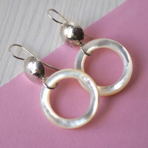 Silver earrings with mother of pearl circle and hammered deep top