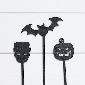 Closeup of monster/Frankenstein, bat and pumpkin Halloween cupcake topper