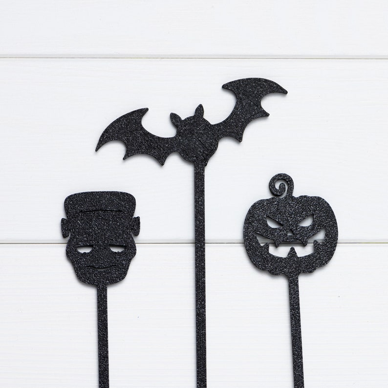 Closeup of monster/Frankenstein, bat and pumpkin Halloween cupcake topper