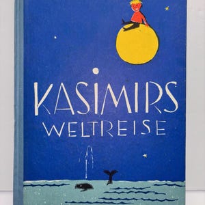 May include: A vintage book cover with a blue background and the title "KASIMIRS WELTREISE" in white. The cover features an illustration of a child sitting on a yellow sphere, with a whale and water in the lower portion. The author's name, Marlene Reidel, is at the top.