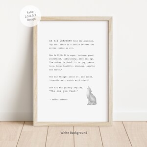 May include: A framed print with a white background and a light wood frame. The print features a quote about two wolves, with a small illustration of a howling wolf. The text includes the phrase "The one you feed."