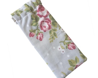 May include: A gray and white floral fabric pouch with a silver clasp closure. The pouch has a floral pattern with pink roses and green leaves.
