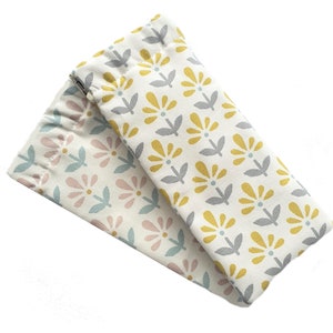 May include: Two fabric pouches with floral patterns. One pouch has a yellow and gray floral pattern, and the other has a pink and blue floral pattern.