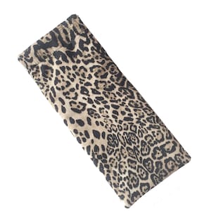 May include: A brown and black leopard print fabric pouch. The pouch is folded and lying flat on a white background.