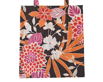 May include: A brown tote bag with a floral print featuring orange, pink, and white flowers on a dark brown background.