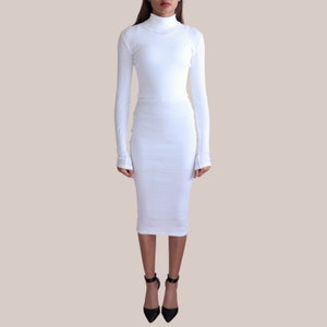 May include: A white long-sleeved turtleneck dress with a fitted silhouette.