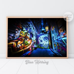 May include: A colorful graffiti alleyway with vibrant blue, yellow, orange, and green paint. The alleyway is narrow and dark, with a skull painted on the wall at the end.