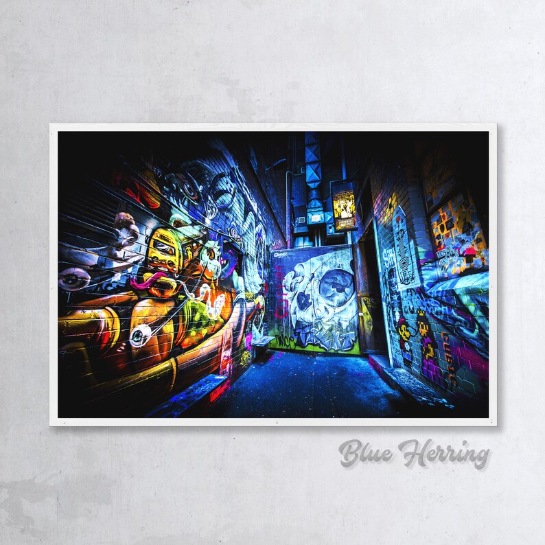 May include: A narrow alleyway with graffiti art on the walls. The walls are covered in colorful spray paint, including a skull, a cartoon character, and other abstract designs. The alleyway is lit by a single streetlight.