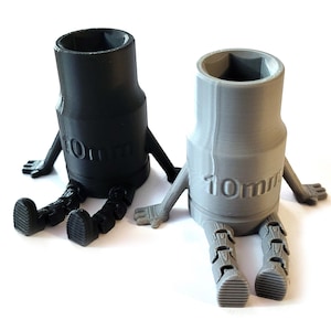 May include: Two 10mm socket wrenches with arms and legs, one black and one gray.