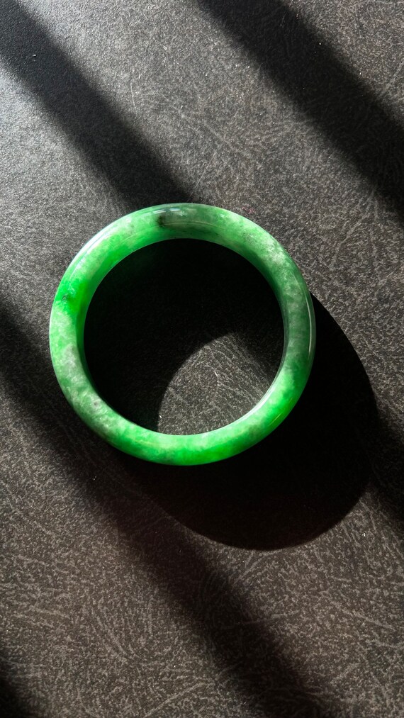 A full green natural  translucent jadeite bangle