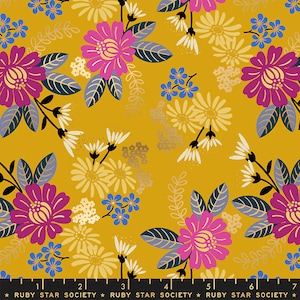 May include: A yellow fabric with a floral pattern. The flowers are pink, yellow, and blue. The fabric has a gold metallic sheen.