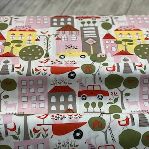 May include: White fabric with a repeating pattern of colorful houses, trees, cars, and birds. The houses are pink, yellow, and gray with red roofs. The trees are green with brown trunks. The cars are red and yellow. The birds are red, yellow, and blue.