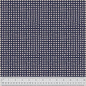 May include: Navy blue fabric with a repeating pattern of off-white polka dots. The dots are evenly spaced and have a slightly irregular shape. A ruler is at the bottom, showing inches.