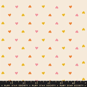 May include: A seamless pattern featuring a repeating design of small hearts in shades of pink, orange, and yellow on a cream background.