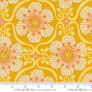 May include: Yellow fabric with a white and pink floral pattern. The fabric has a repeating pattern of stylized flowers with a central circle and a ring of smaller circles. The fabric is 44 inches wide.